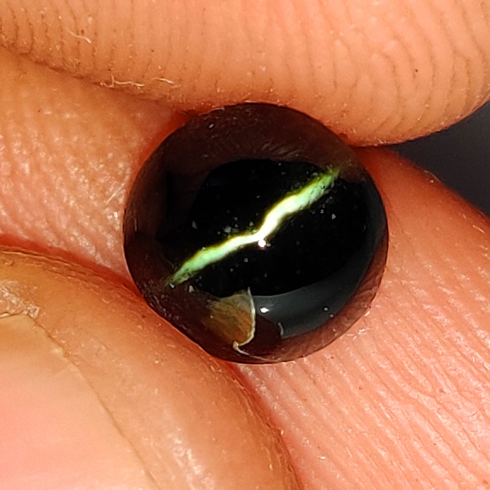 1.63 Ct Natural Sharp Line Kornerupine Cat'seye Oval Cab: Weight - 1.63 Ct / Dimensions - 6.50 x 6.20 x 5.10 mm / Shape - Oval Cab / Color - Black / Clarity - Opaque / Origin - India / Treatment - Npne