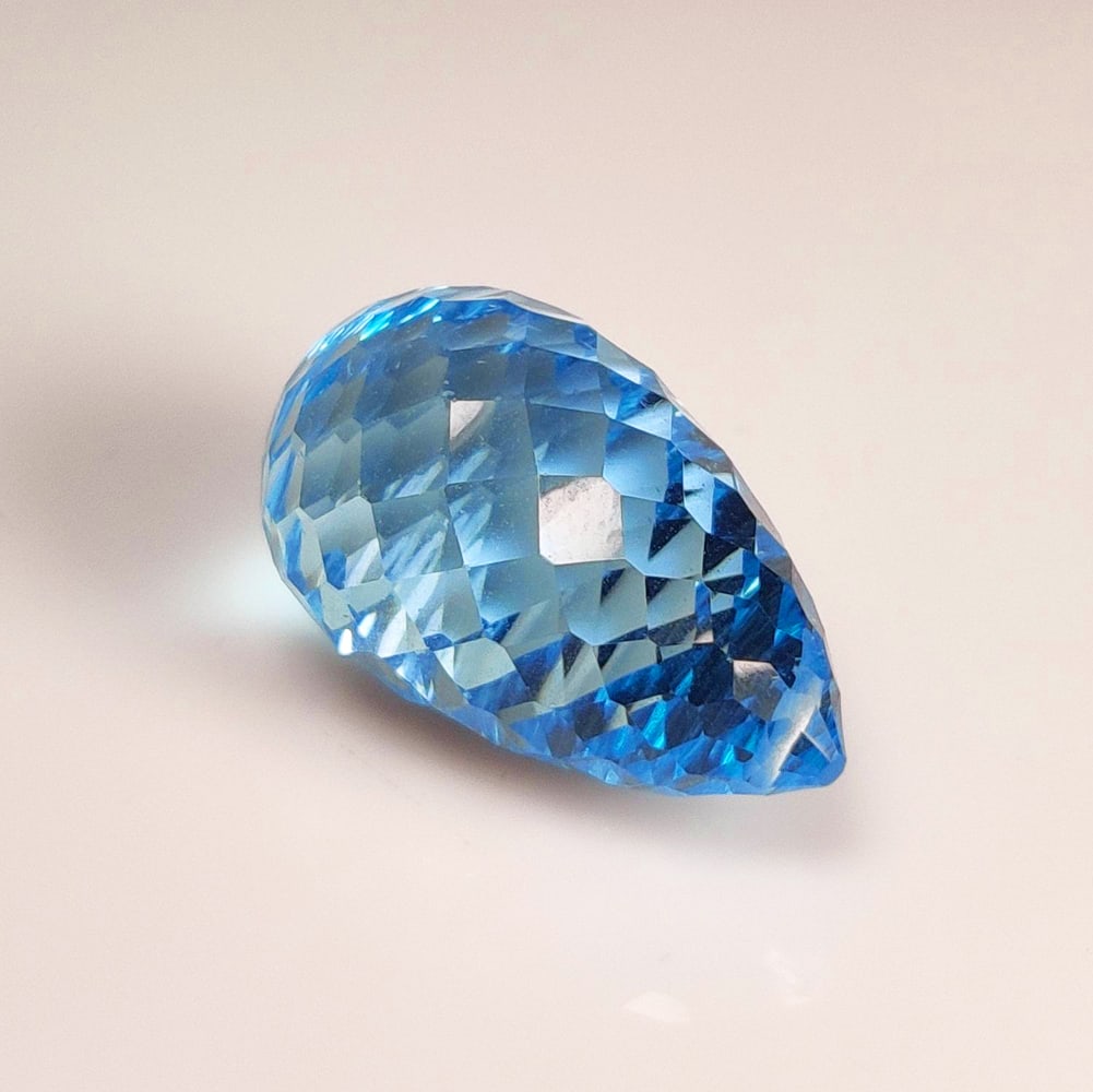 24.57 Ct Natural Blue Topaz Fancy Drilled Pear Drop: Weight - 24.57 Ct / Dimensions - 22.00 x 11.60 x 11.60 mm / Shape - Drilled Pear Drop / Color - Blue / Clarity - VVS / Origin - Brazil / Treatment - Irradiated