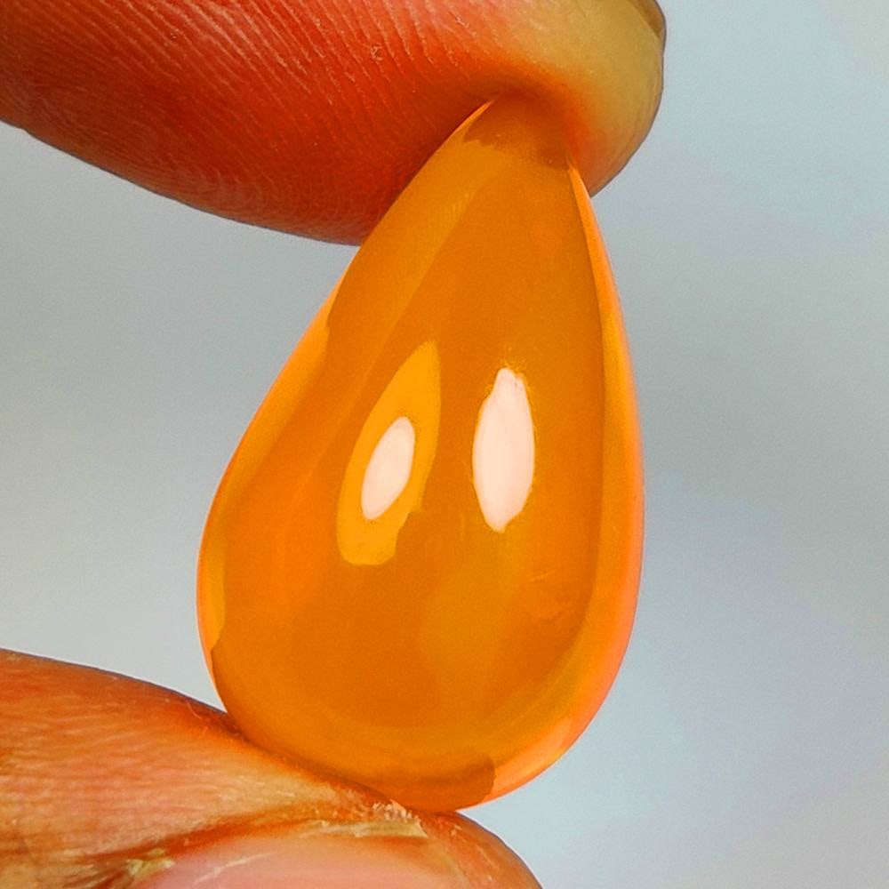 7.57 Ct Natural Orange Fire Opal Pear Cab: Weight - 7.57 Ct / Dimensions - 19.30 x 11.50 x 8.20 mm / Shape - Pear Cab / Color - Orange / Clarity - Transparent / Origin - Ethiopia / Treatment - Heated