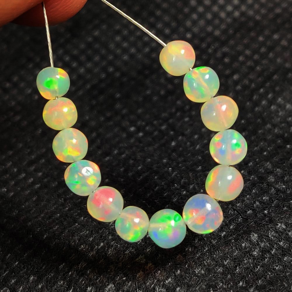 4.39 Ct Natural Multicolor Welo Opal Fire Round Ball Beads: Weight - 4.39 Ct / Dimensions - 3.90 - 4.60 mm / 13 Pc's / Shape & Cut - Round Beads / Color - Multicolor / Transparency - Translucent / Origin - Ethiopia / Comments - None