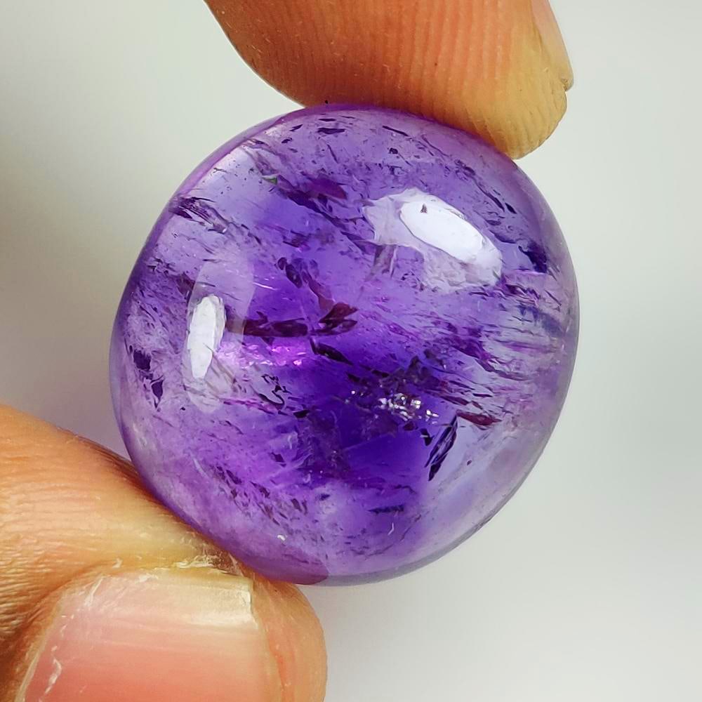 33.51 Ct Natural Rutile Purple Amethyst Oval Cab: Weight - 33.51 Ct / Dimensions - 22.00 x 20.00 x 10.00 mm / Shape - Oval Cab / Color - Purple / Clarity - VVS / Origin -Brazil / Treatment - Heated