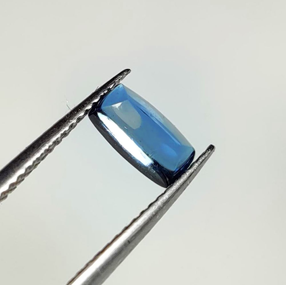 1.30 Ct Natural London Blue Topaz Cushion Cab: Weight : 1.30 Ct / Dimensions : 7.80 x 4.00 x 3.90 mm / Shape : Cushion Cab / Color : Blue / Transparency : Transparent / Treatment : Irradiated