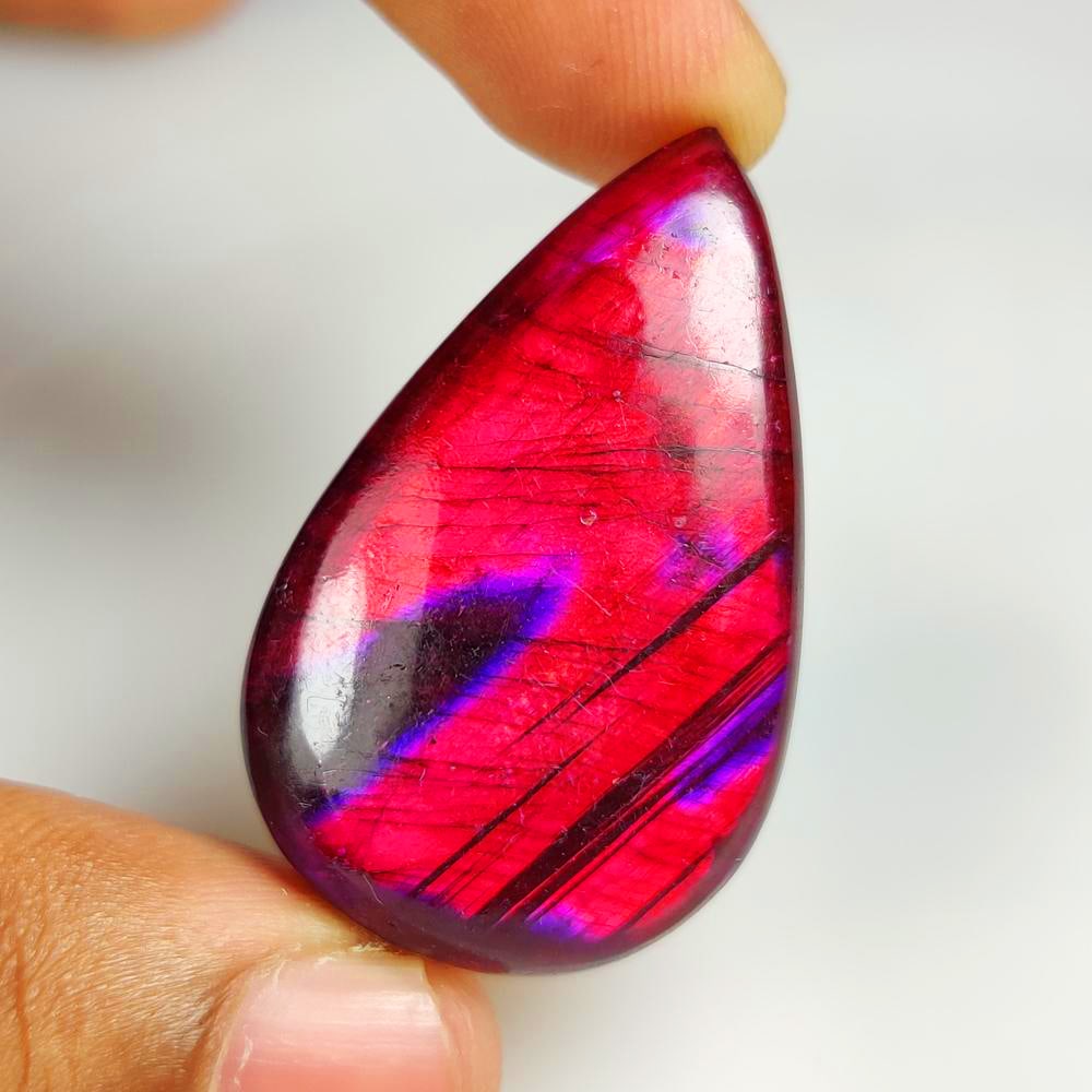 62.11 Ct Natural Purple Flashing Lapis Lazuli Pear Cab: Weight - 62.11 Ct / Dimensions - 43.00 x 27.00 x 7.60 mm / Shape - Pear Cab / Clarity - Opaque / Origin - Afghanisthan / Treatment - None