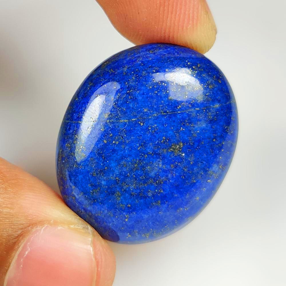 53.58 Ct Natural Blue Lapis Lazuli Oval Cab: Weight - 53.58 Ct / Dimensions - 31.00 x 27.00 x 7.60 mm / Shape - Oval Cab / Clarity - Opaque / Origin - Afghanisthan / Treatment - None