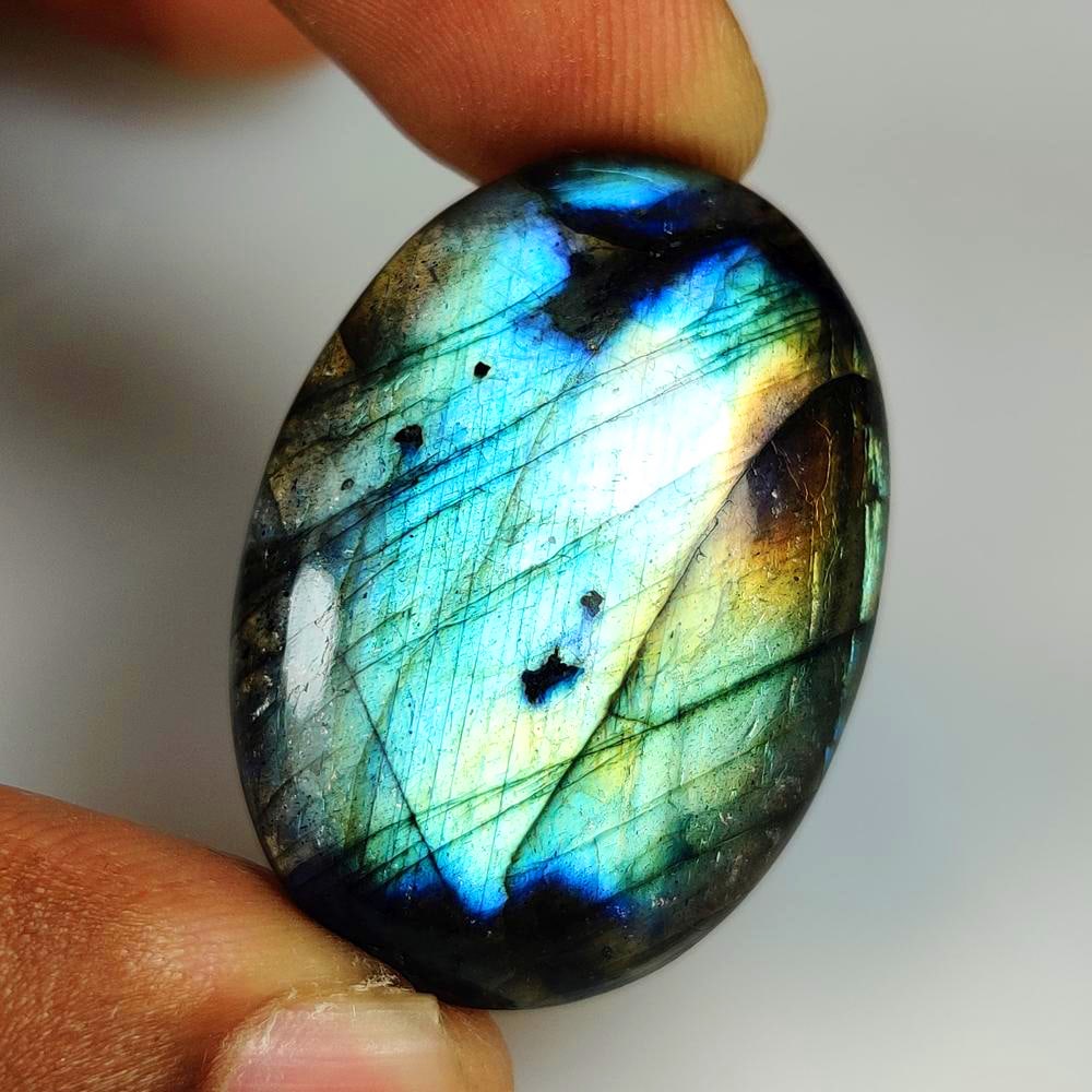 57.66 Ct Natural Flashing Labradorite Oval Cab: Weight - 57.66 Ct / Dimensions - 36.00 x 27.00 x 7.80 mm / Shape - Excellent Oval Cab / Clarity - Opaque / Origin - Africa / Treatment - None