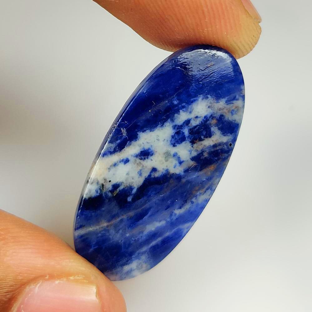 16.75 Ct Natural Blue Sodalite Oval Cab: Weight - 16.75 Ct / Dimensions - 33.00 x 15.20 x 3.90 mm / Shape - Oval Cabochon / Color - Blue / Clarity - Opaque / Origin -Brazil / Treatment - None
