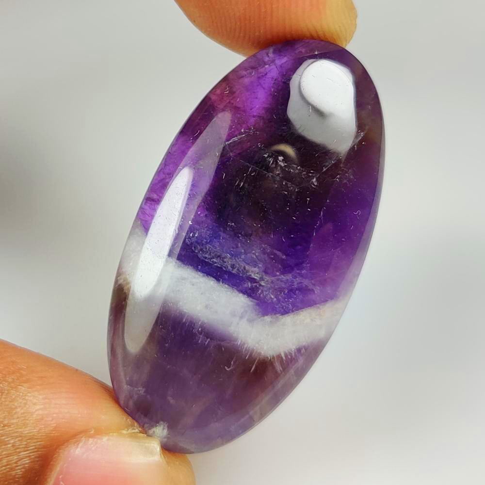 43.19 Ct Natural Chevron Amethyst Oval Cab: Weight - 43.19 Ct / Dimensions - 39.00 x 20.10 x 7.10 mm / Shape - Oval Cab / Clarity - Opaque / Origin - Brazil / Treatment - None