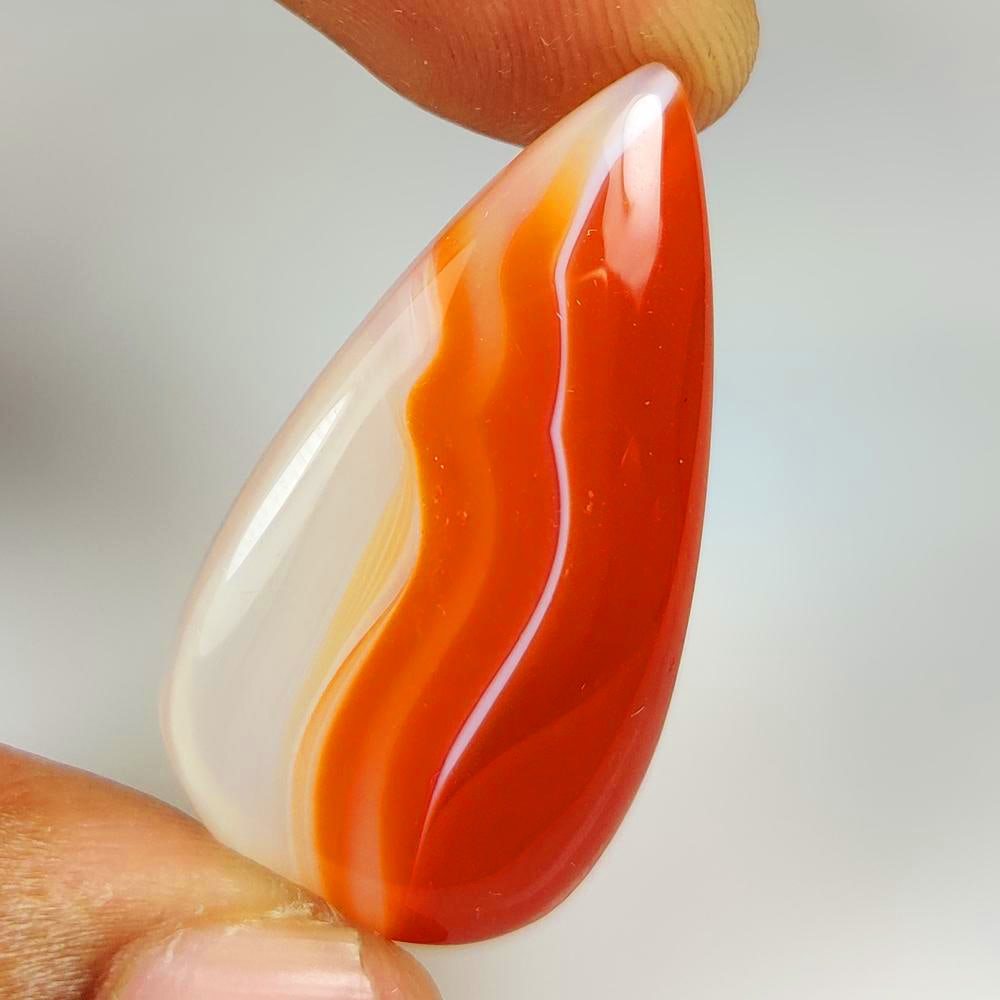 27.86 Ct Natural Orange Botswana Agate Pear Cab: Weight - 27.86 Ct / Dimensions - 36.00 x 18.70 x 5.90 mm / Shape - Pear Cab / Clarity - Opaque / Origin - Bostswana / Treatment - None