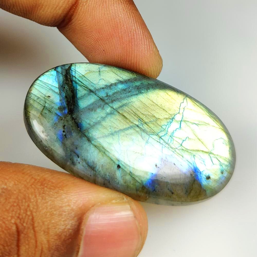 63.28 Ct Natural Flashing Labradorite Oval Cab: Weight - 63.28 Ct / Dimensions - 47.00 x 27.00 x 6.20 mm / Shape - Excellent Oval Cab / Clarity - Opaque / Origin - Africa / Treatment - None