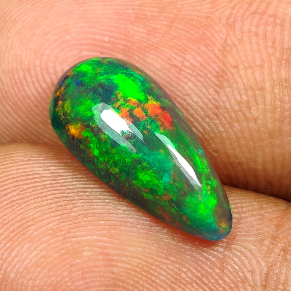 2.26 Ct Natural Black Flashing Fire Opal Pear Cab: Weight - 2.26 Ct / Size - 14.50 x 7.10 x 4.90 mm / Shape - Pear Cab / Color - Black / Transparency - Translucent / Origin - Ethiopia / Treatment - Color Smoked