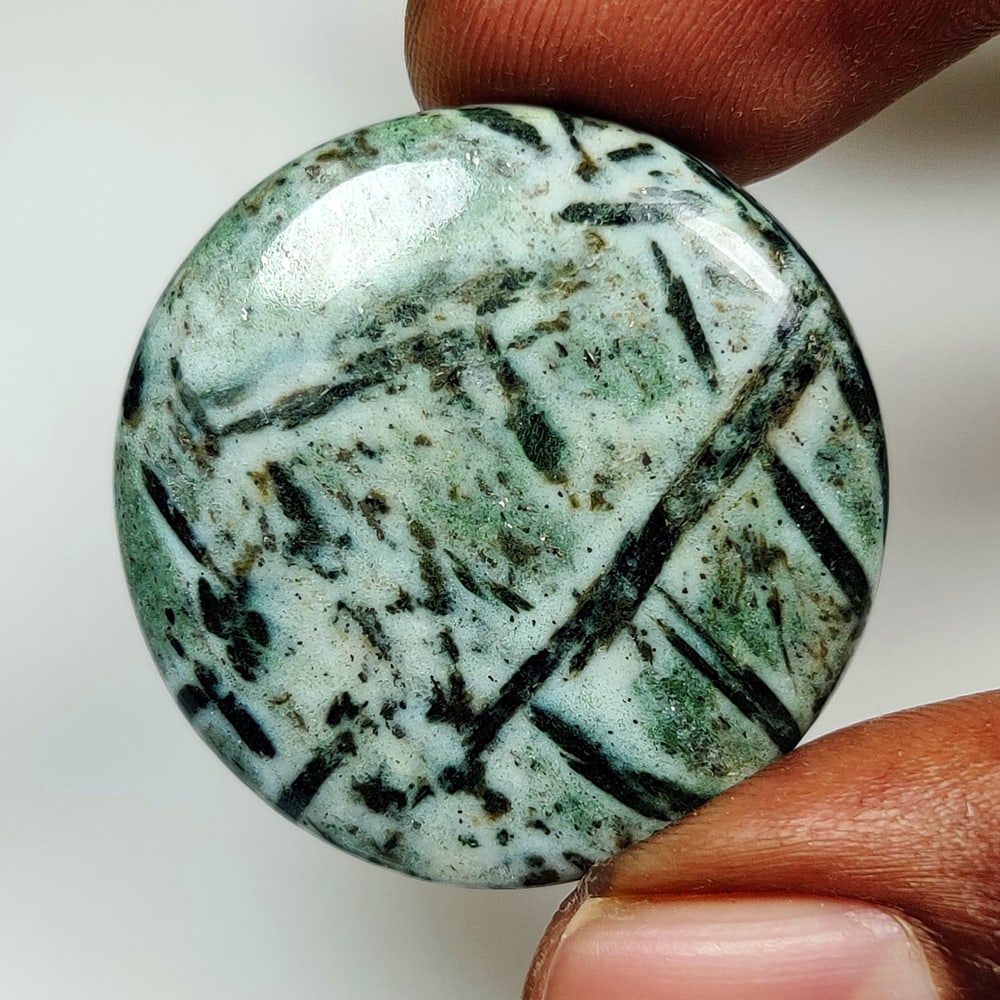 39.87 Ct Natural Hornblende Round Cab: Weight - 39.87 Ct / Dimensions - 31.00 x 31.00 x 5.30 mm / Shape - Round Cab / Clarity - Translucent / Origin - Brazil / Treatment - None