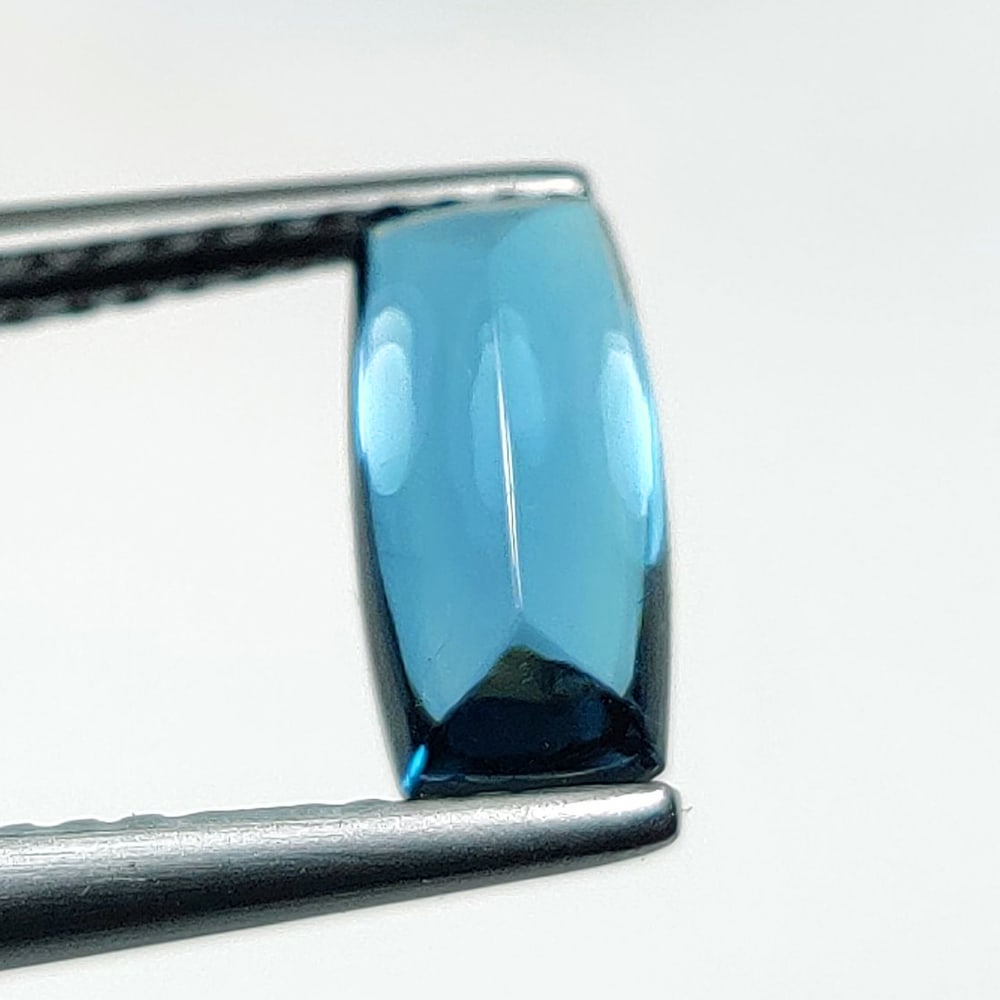 1.61 Ct Natural London Blue Topaz Cushion Cab: Weight : 1.61 Ct / Dimensions : 9.30 x 4.50 x 3.80 mm / Shape : cushion Cab / Color : Blue / Transparency : Transparent / Treatment : Irradiated
