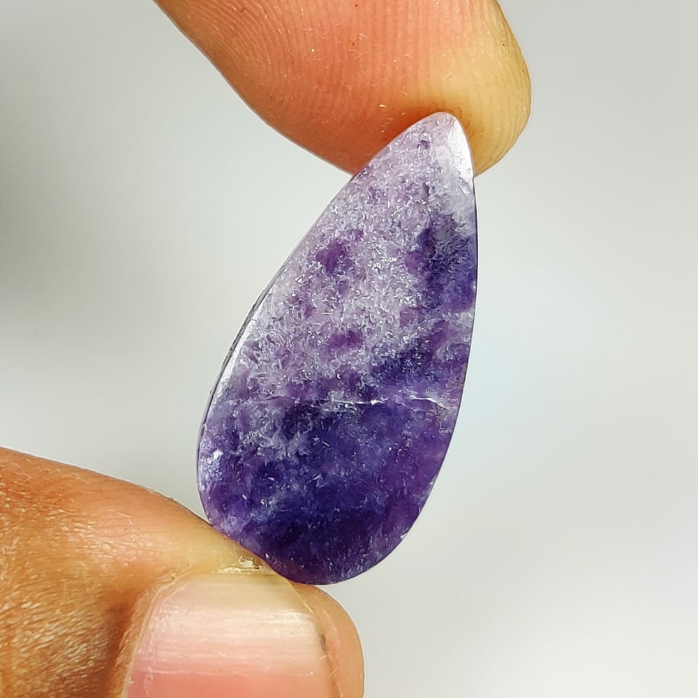 12.88 Ct Natural Purple Charoite Pear Cab: Weight - 12.88 Ct / Size - 25.10 x 12.20 x 4.40 mm / Shape - Excellent Pear Cab / Clarity - Opaque / Origin - Brazil / Treatment - None