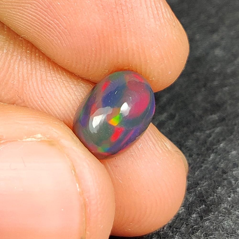 1.52 Ct Natural Black Flashing Fire Opal Oval Cab (1 of 3)