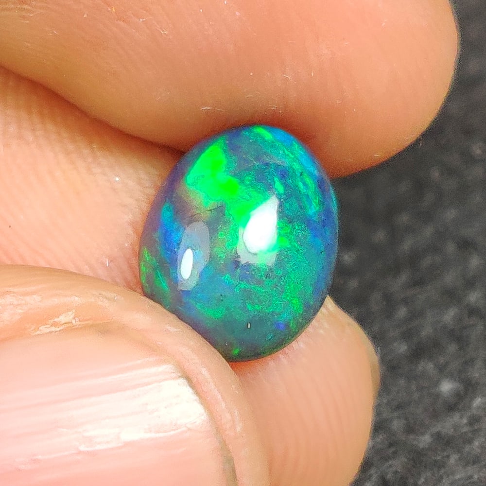 1.51 Ct Natural Black Flashing Fire Opal Oval Cab (1 of 2)