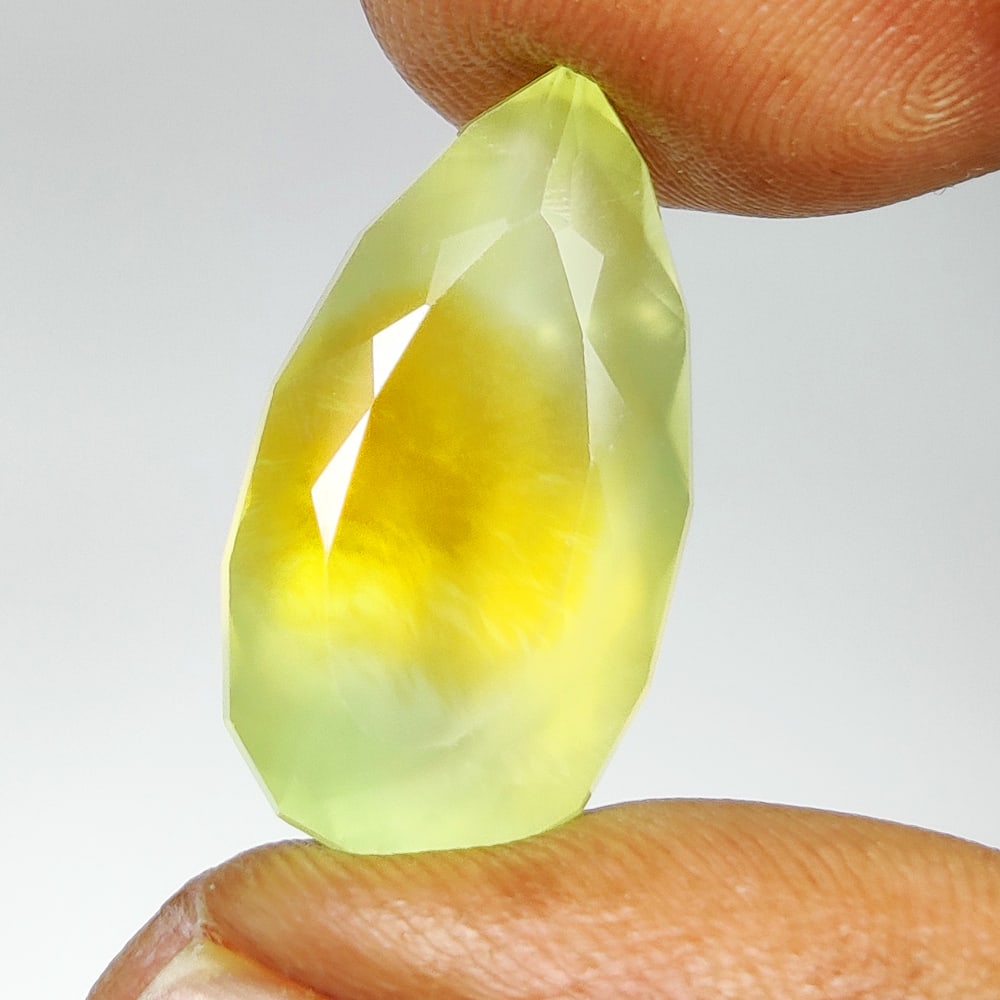 10.46 Ct Natural Prehnite Pear Cut: Weight - 10.46 Ct / Size - 20.00 x 11.20 x 8.00 mm / Shape - Pear Cut / Clarity - Semi Transaprent / Origin - Brazil / Treatment - None