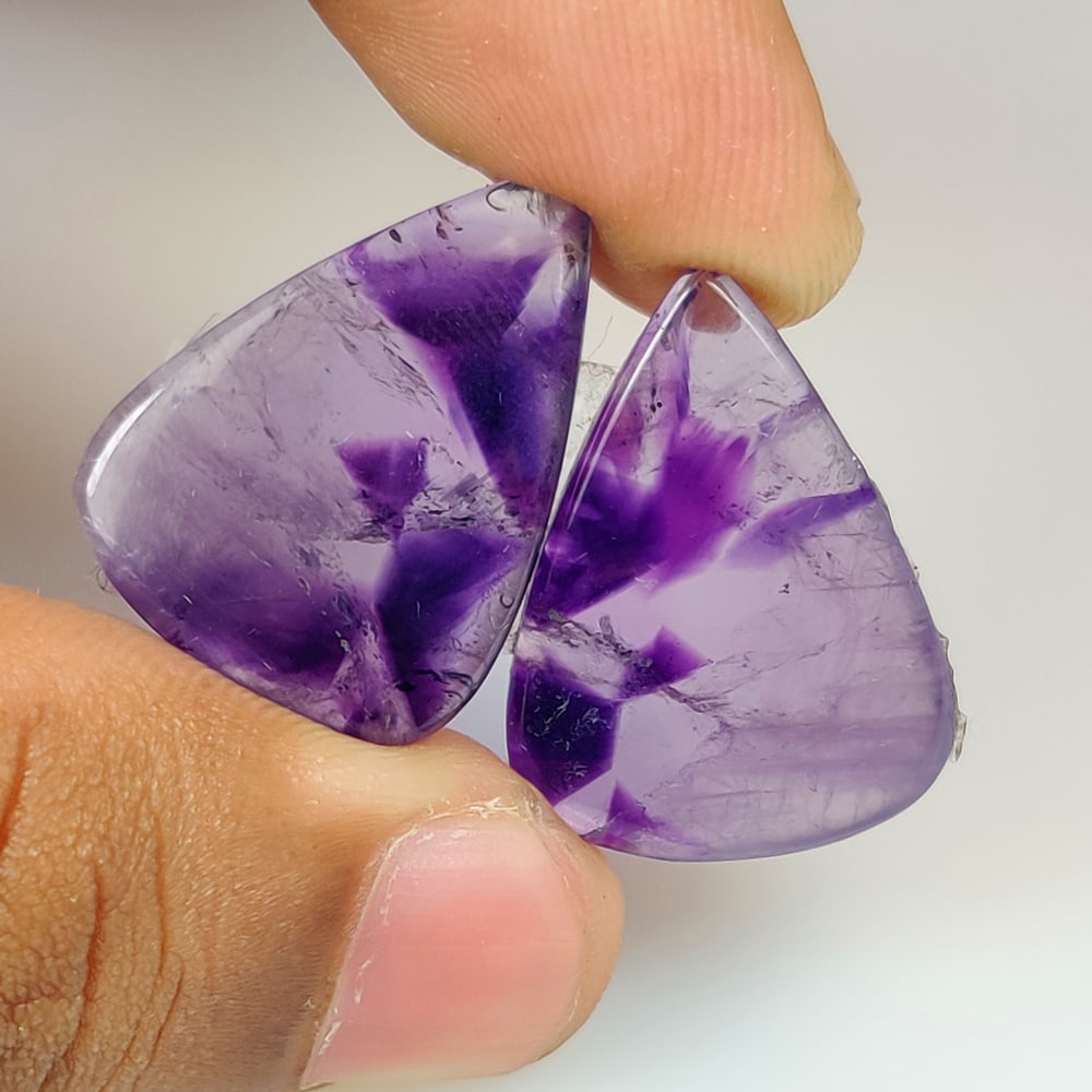 31.09 Ct Natural Star Amethyst Pear Cab Pair: Weight - 31.09 Ct / Dimensions - 24.30 x 18.10 x 4.50 mm / 2 PC's / Shape Pear Cab / Clarity - Trnsparent / Origin - Brazil / Treatment - None