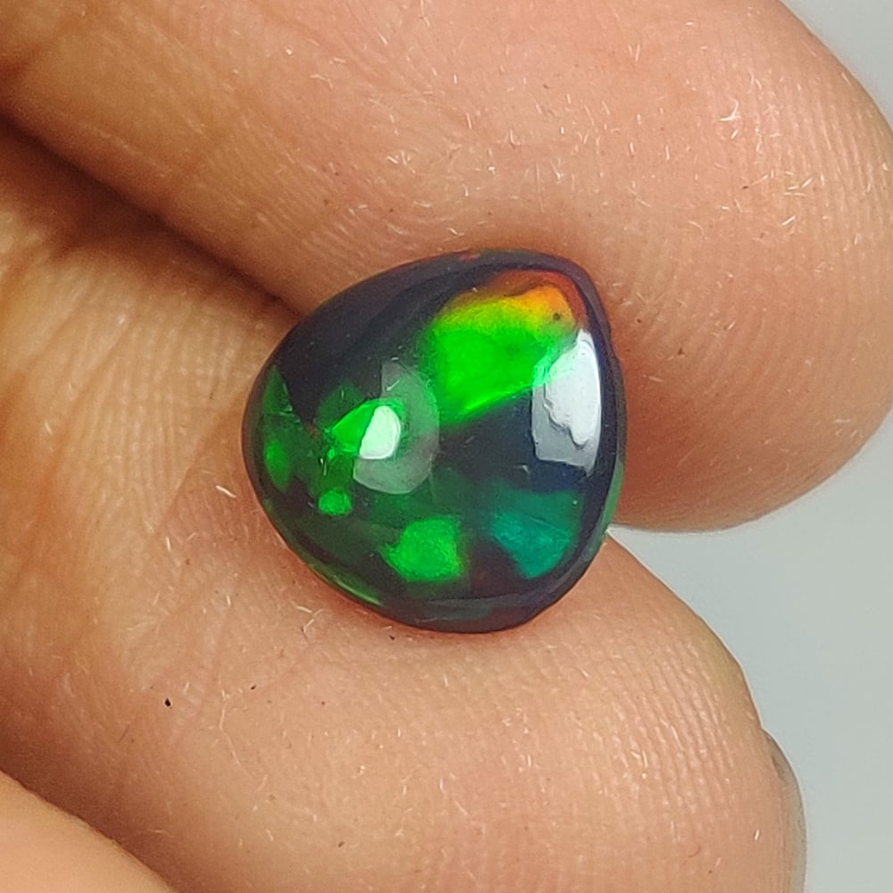 0.70 Ct Natural Black Flashing Fire Opal Pear Cab: Weight - 0.70 Ct / Dimensions - 8.20 x 8.10 x 2.50 mm / Shape - Pear Cab / Color - Black / Clarity - Translucent / Origin - Ethiopia / Treatment - Color Smoked