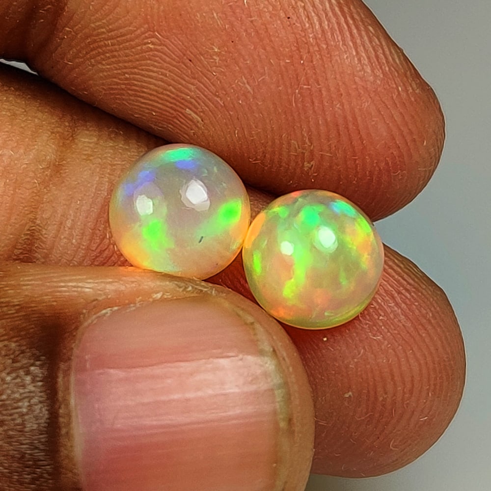 3.33 Ct Natural Multicolor Welo Opal Flash Fire Round Cab Pair: Weight - 3.33 Ct / Dimensions - 8.10 x 8.10 x 5.00 mm / 2 Pc's / Shape - Round Cab / Color - Multicolor / Clarity - Translucent / Origin - Ethiopia / Treatment - None