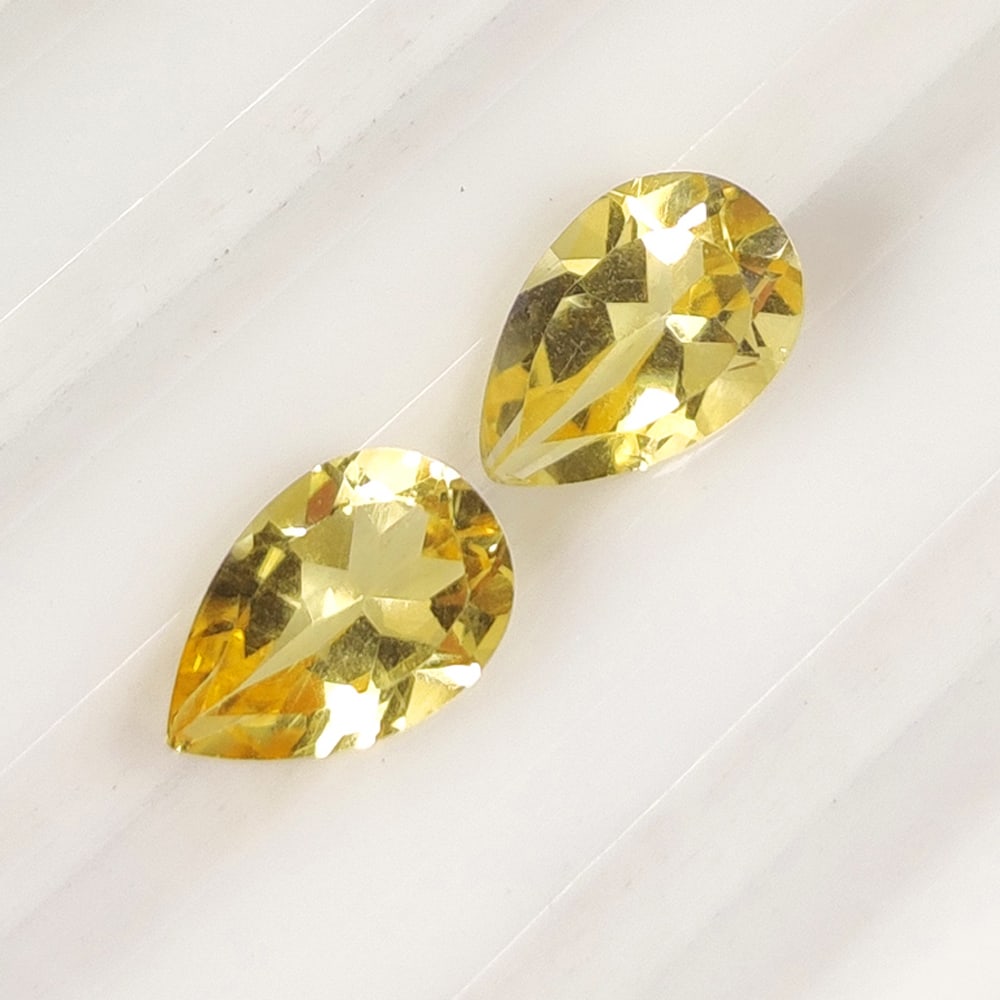 2.43 Ct Natural Yellow Citrine Pear Cut Pair: Weight - 2.43 Ct / Size - 9.10 x 6.00 x 4.60 mm / 2 Pc's / Shape - Pear Cut / Color - Yellow / Clarity - VVS / Origin - Brazil / Treatment - Heated