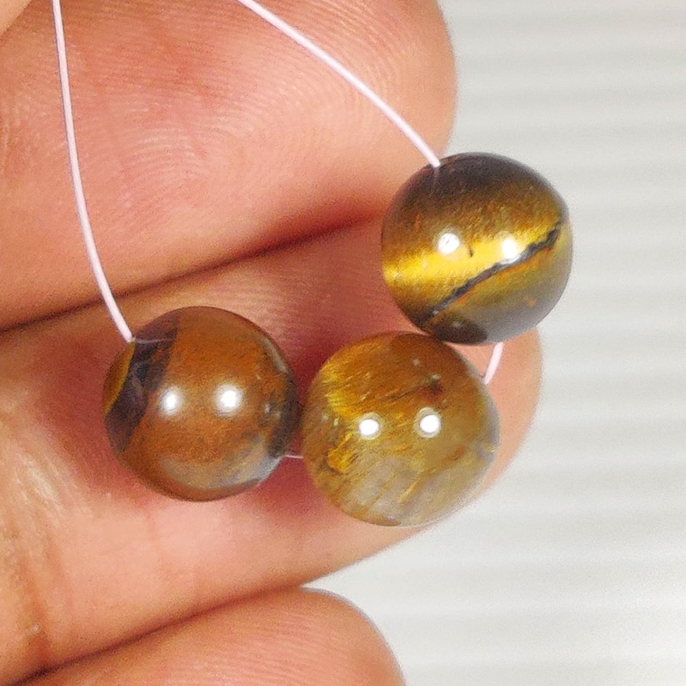 12.86 Ct Natural Tiger Eye Round Ball Beads: Weight - 12.86 Ct / Size - 8.30 - 8.50 mm / 3 Pc's / Shape - Round Ball Beads / Color - Golden Brown / Clarity - Opaque / Origin - Burma / Treatment - None