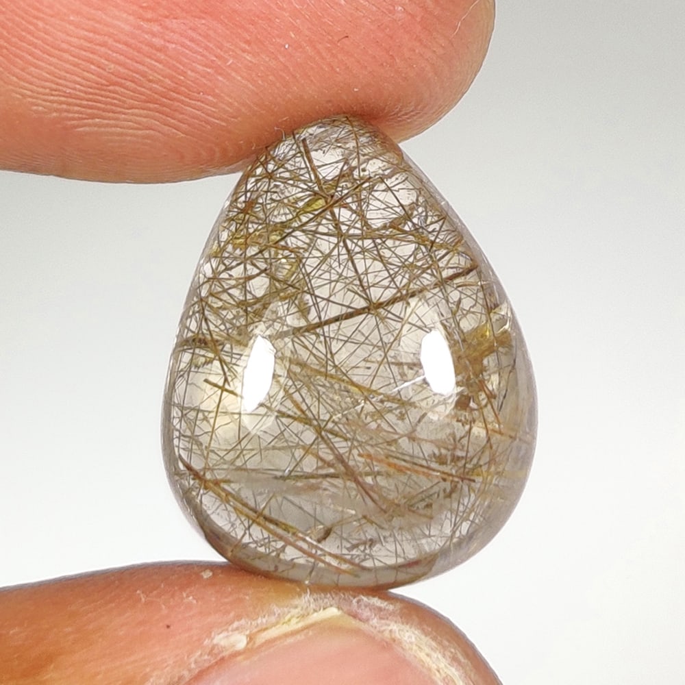 14.80 Ct Natural Rutile Quartz Pear Cab: Weight - 14.80 Ct / Dimensions - 18.40 x 14.30 x 8.00 mm / Shape - Pear Cab / Clarity - Transparent / Origin - Norway / Treatment - None
