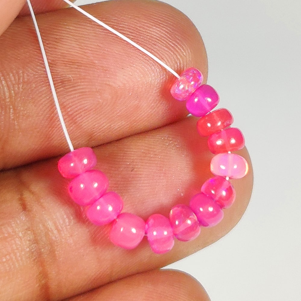 3.25 Ct Natural Drilled Pink Fire Opal Round Beads: Weight - 3.25 Ct / Dimensions - 3.80 - 4.40 mm / 13 No's / Shape - Drilled Round Beads / Color - Pink / Clarity - Transparent / Origin - Ethiopia / Treatment - Heated