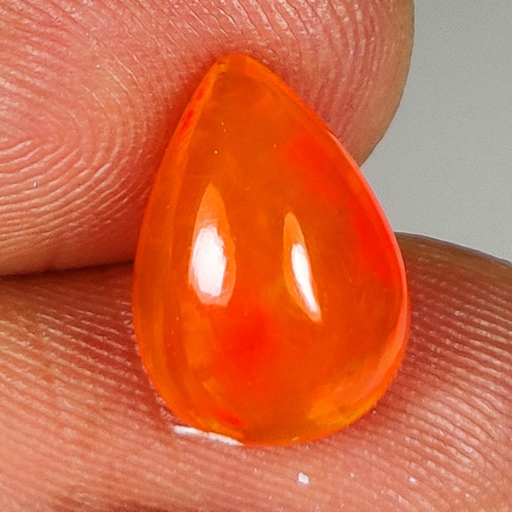 2.16 Ct Natural Orange Flashing Fire Opal Pear Cab: Weight - 2.16 Ct / Dimensions - 12.30 x 8.20 x 5.10 mm / Shape - Pear Cab / Color - Orange / Clarity - Translucent / Origin - Ethiopia / Treatment - Heated