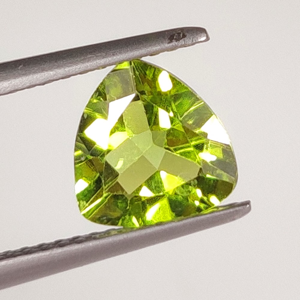 1.63 Ct Natural Green Peridot Trillion Cut: Weight - 1.63 Ct / Dimensions - 8.00 x 8.00 x 4.00 mm / Shape - Trillion Cut / Color - Green / Clarity - VVS / Origin - Pakistan / Treatment - None
