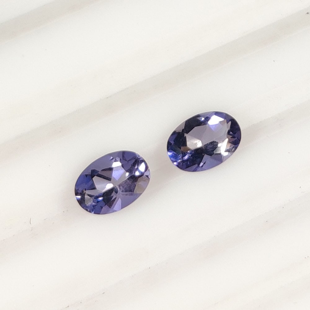 1.27 Ct Natural Iolite Oval Cut Pair: Weight - 1.27 Ct / Dimensions - 7.00 x 5.00 mm / 2 PC's / Shape - Oval Cut / Color - Deep Violet / Clarity - VVS / Origin - Nigeria / Treatment - None