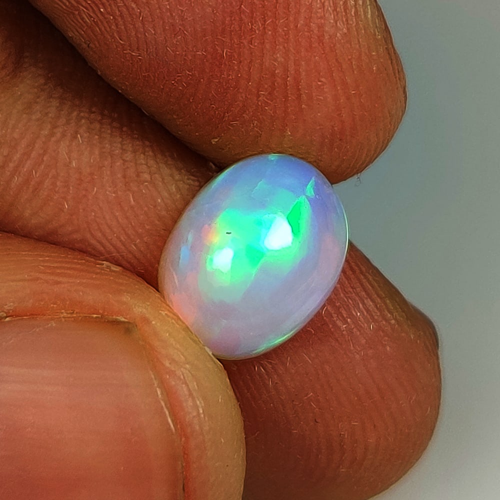 2.20 Ct Natural Multicolor Welo Opal Top Fire Oval Cab: Weight - 2.20 Ct / Size - 10.00 x 7.80 x 5.50 mm / Shape - Oval cab / Color - Multicolor / Clarity - Translucent / Origin - Ethiopia / Treatment - None