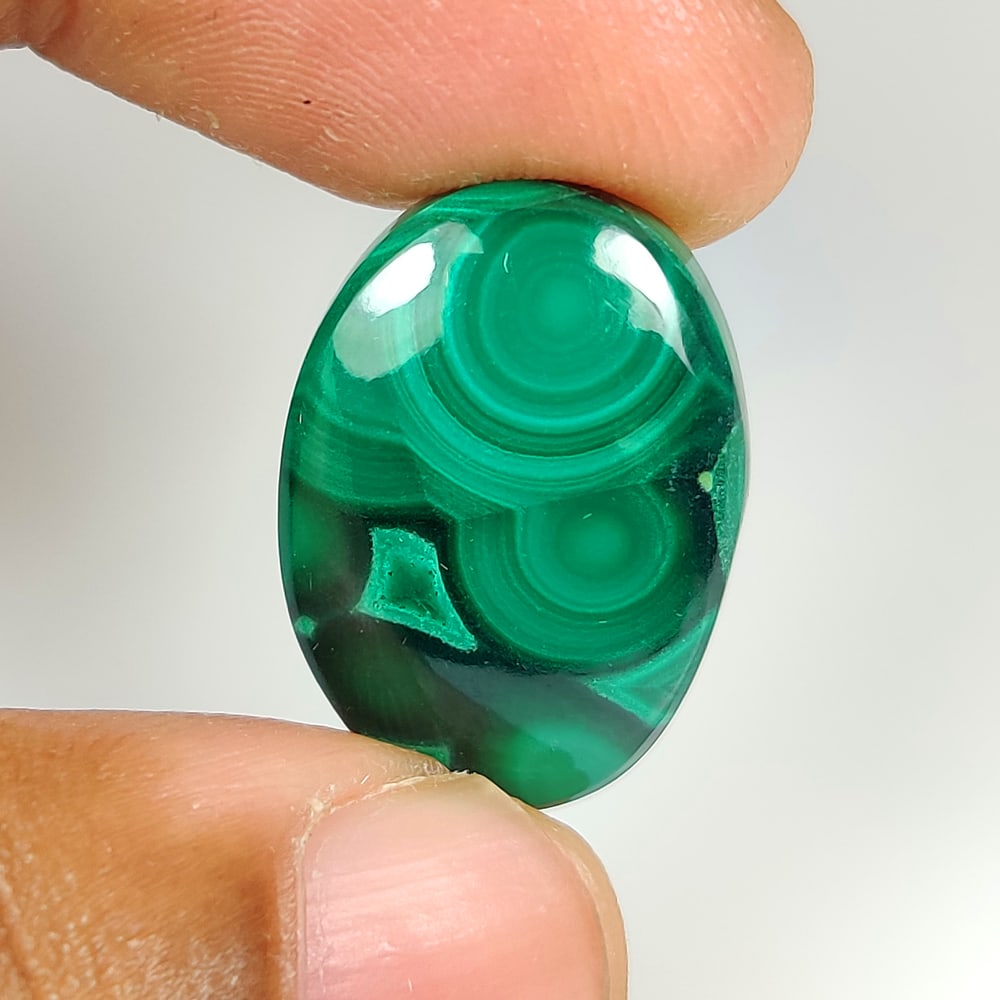 23.10 Ct Natural Green Malachite Oval Cab: Weight - 23.10 Ct / Dimensions - 22.00 x 15.60 x 5.60 mm / Shape - Oval Cab / Color - Green / Clarity - Opaque / Origin - Russia / Treatment - None