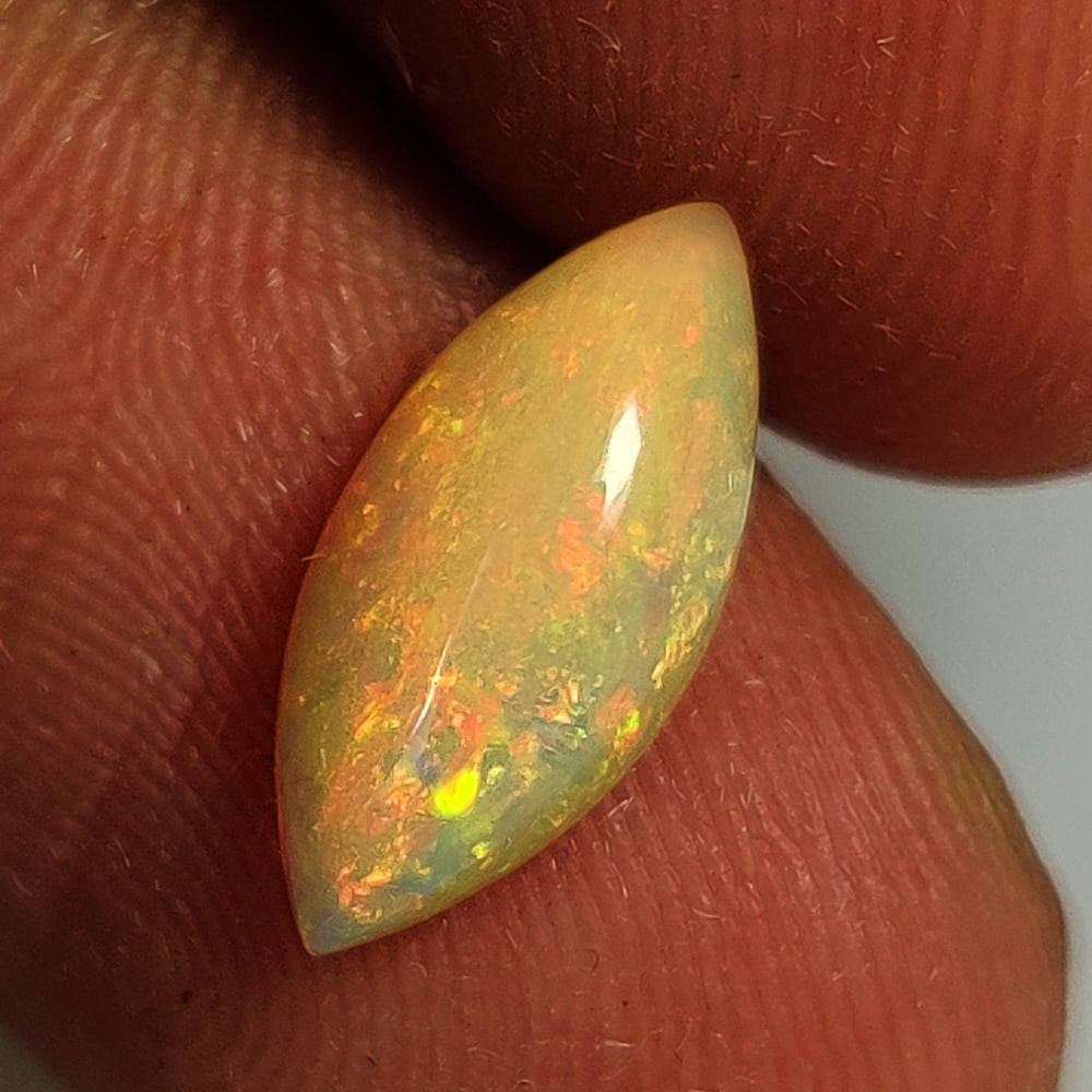 1.25 Ct Natural Multicolor Welo Opal Flash Fire Marquise Cab: Weight - 1.25 Ct / Dimensions - 6.10 x 3.10 x 3.80 mm/ Shape & Cut - Marquise Cab / Color - Multicolor / Transparency - Translucent / Origin - Ethiopia / Comments - None