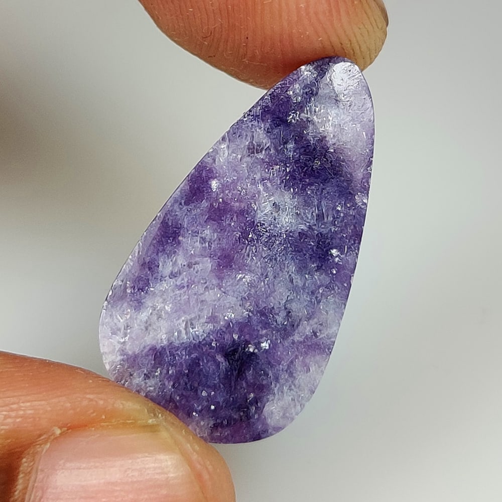 11.55 Ct Natural Purple Charoite Pear Cab: Weight - 11.55 Ct / Dimensions -24.80 x 13.90 x 3.60 mm / Shape - Pear Cab / Color - Purple / Clarity - Opaque / Origin - Russian Federation / Treatment - None