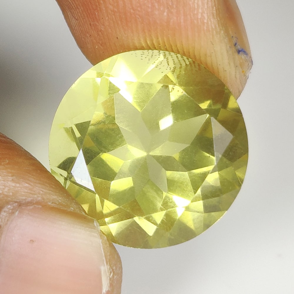 13.68 Ct Natural Lemon Quartz Round Cut: Weight - 13.68 Ct / Dimensions - 16.00 x 16.00 x 10.30 mm / Top Quality Luster / Excellent Round Cut / Origin - Brazil / Comments - Heated