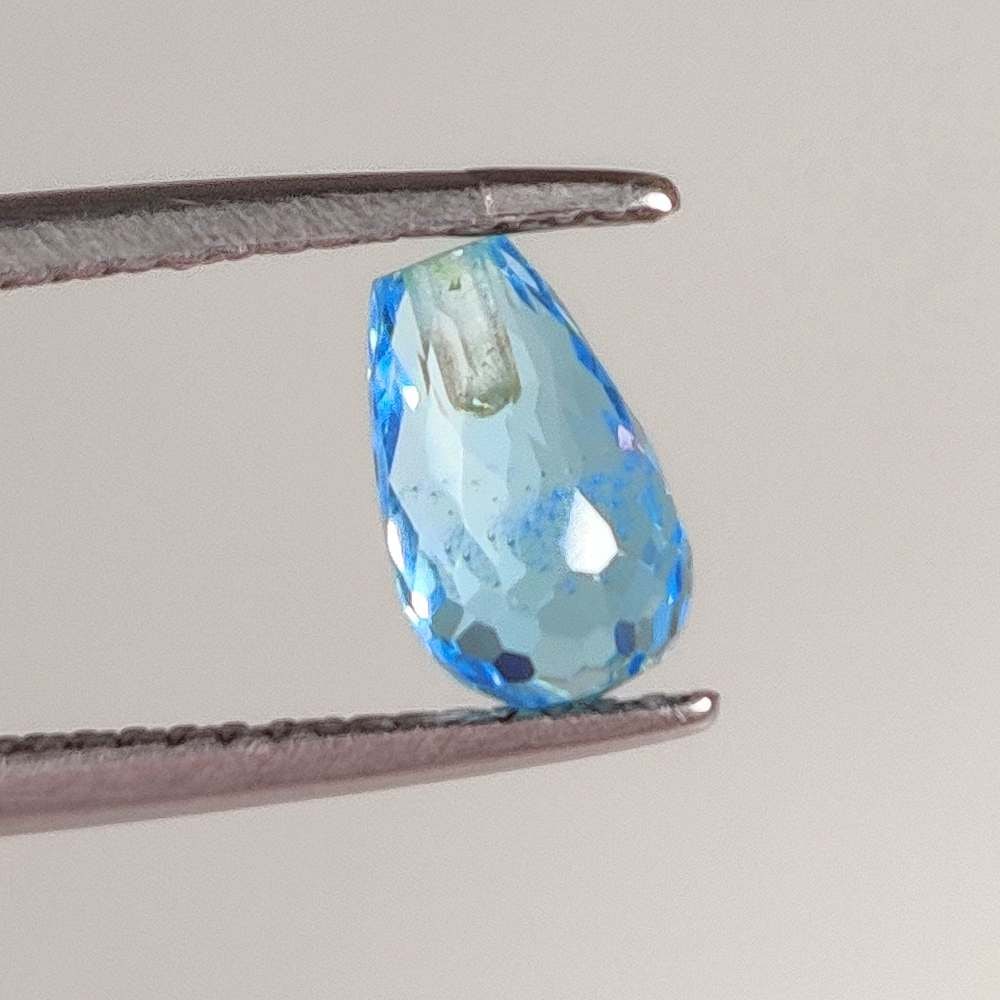 1.79 Ct Natural Blue Topaz Pear Drop: Weight - 1.79 Ct / Dimensions 8.20 x 5.00 x 5.00 mm / Shape Pear Dop / Color - Blue / Clarity - VVS / Origin - Brazil / Treatment - Irradiated