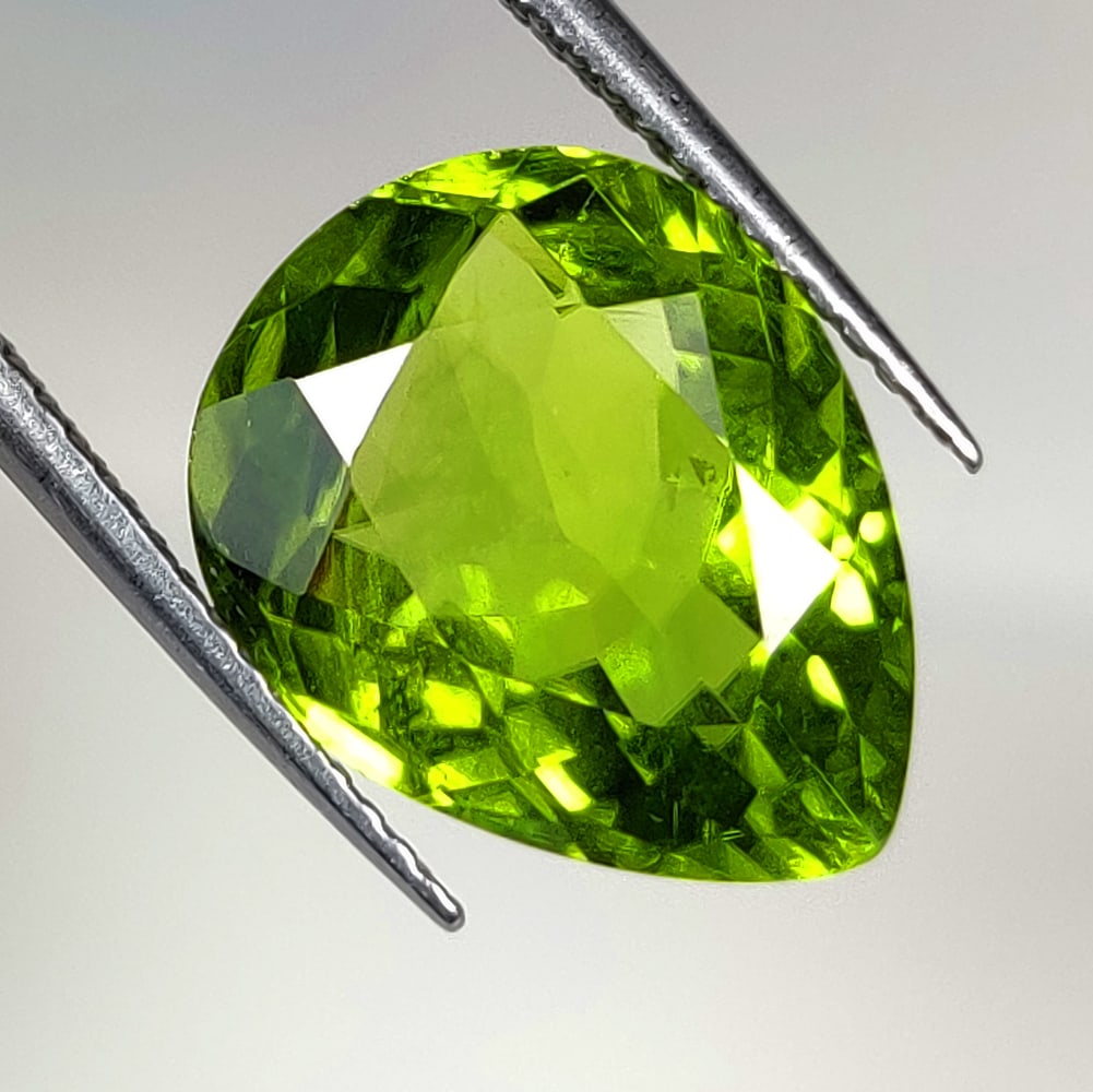 7.03 Ct Natural Green Peridot Pear Cut: Weight - 7.03 Ct / Size - 14.20 x 11.40 x 6.60 mm / Shape - Pear Cut / Color - Green / Clarity - VVS / Origin - Pakistan / Treatment - None