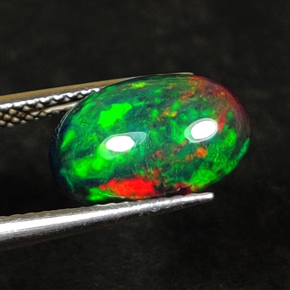 2.76 Ct Natural Black Flashing Fire Opal Oval Cab: Weight - 2.76 Ct / Dimensions - 12.30 x 8.60 x 5.20 mm / Shape - Oval Cab / Color - Black / Clarity - Translucent / Origin - Ethiopia / Treatment - Color Smoked