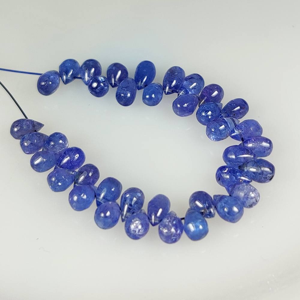 22.72 Ct Natural Tanzanite Pear Drop Drilled Beads: Weight - 22.72 Ct / Dimensions - 5.80 x 3.50 - 6.10 x 4.00 mm / 38 Pc's / Shape - Pear Drop Drilled Beads / Transparency - Transparent / Origin - Tanzania / Treatment - Standard Heated