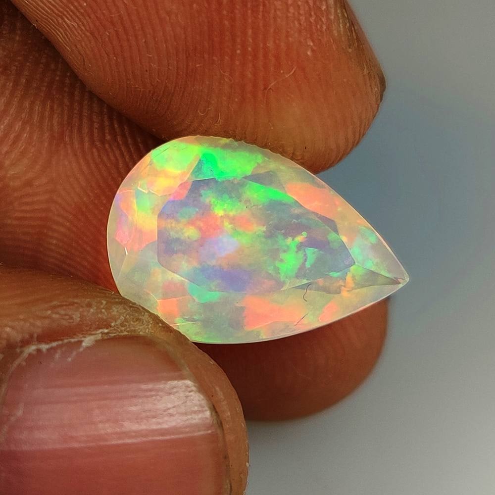 3.92 Ct Natural Multicolor Welo Opal Flash Fire Pear Cut: Weight - 3.92 Ct / Dimensions - 15.00 x 8.40 mm / Shape - Pear Cut / Color - Multicolor / Clarity - Translucent / Origin - Ethiopia / Treatment - None