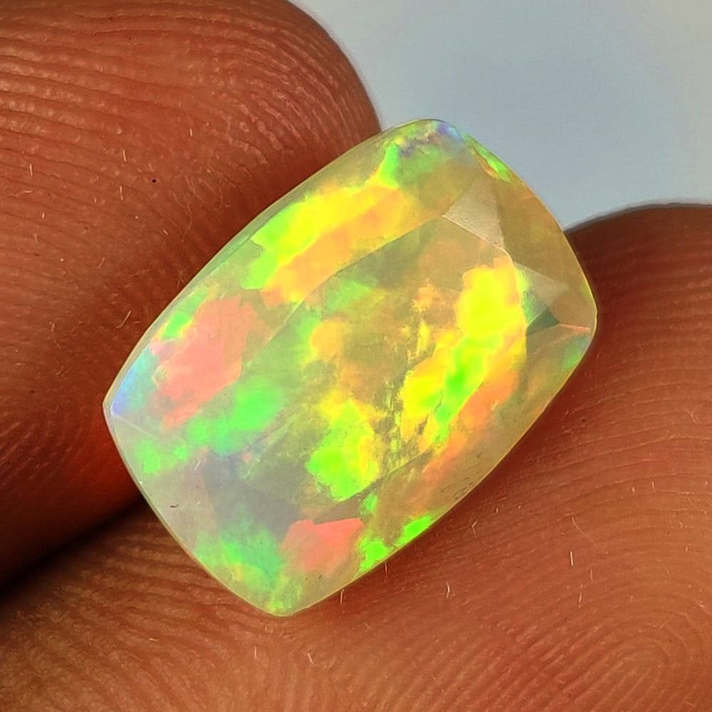 3.82 Ct Natural Multicolor Welo Fire Opal Cushion Cut: Weight - 3.82 Ct / Dimensions - 13.10 x 9.10 x 6.30 mm / Shape - cushion Cut / Color - Multicolor / Clarity - Translucent / Origin - Ethiopia / Treatment - None