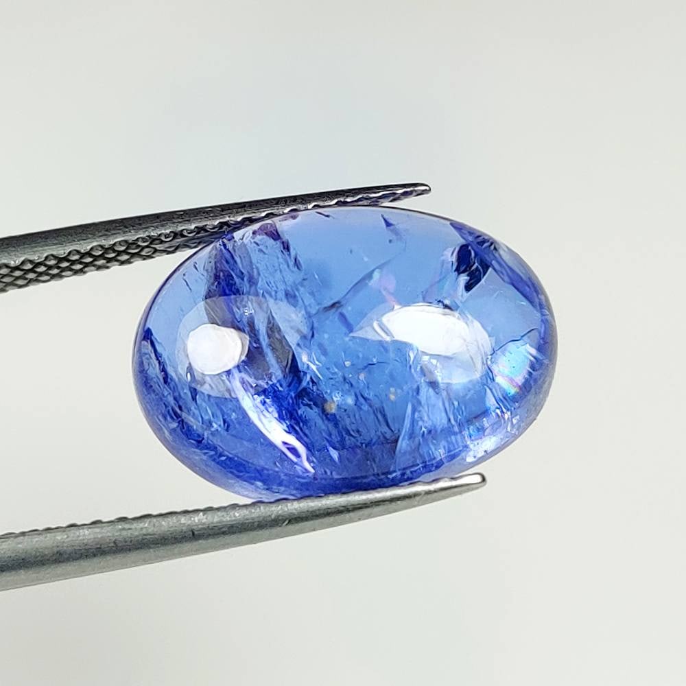 10.02 Ct Natural Tanzanite Oval Cab: Weight : 10.02 Ct / Dimensions : 15.30 x 10.90 x 6.60 mm / Shape : Oval Cab / Color : Purplish Blue / Transparency : Transparent / Treatment : Heated