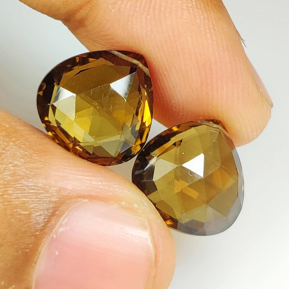 15.95 Ct Natural Champagne Quartz Drilled Pear Cut Pair: Weight - 15.95 Ct / Dimensions -13.20 x 13.20 x 7.90 mm / 2 Pc's / Shape - Drlled Pear Cut / Color - Deep Yellow / Clarity - VVS / Origin - Brazil / Treatment - None