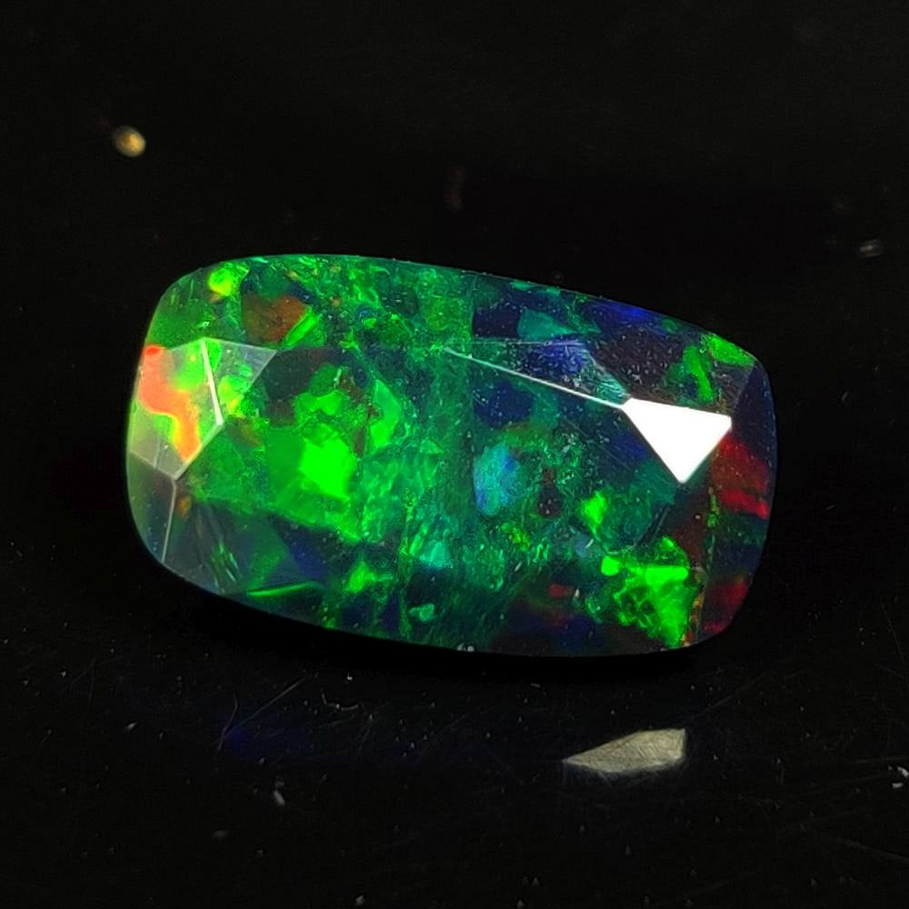 2.82 Ct Natural Black Flashing Fire Opal Cushion Cut: Weight - 2.82 Ct / Dimensions - 13.10 x 7.70 x 6.30 mm / Shape - Cushion cut / Color - Black / Clarity - Translucent / Origin - Ethiopia / Treatment - Color Smoked