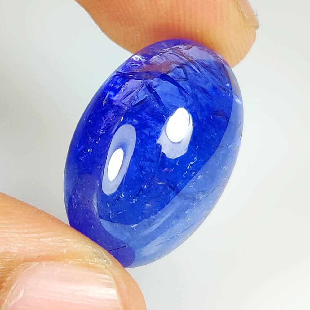 27.18 Ct Natural Tanzanite Oval Cab: Weight : 27.18 Ct / Dimensions : 23.00 x 14.70 x 9.70 mm / Shape : Oval Cab / Color : Purplish Blue / Transparency : Transparent / Treatment : Heated