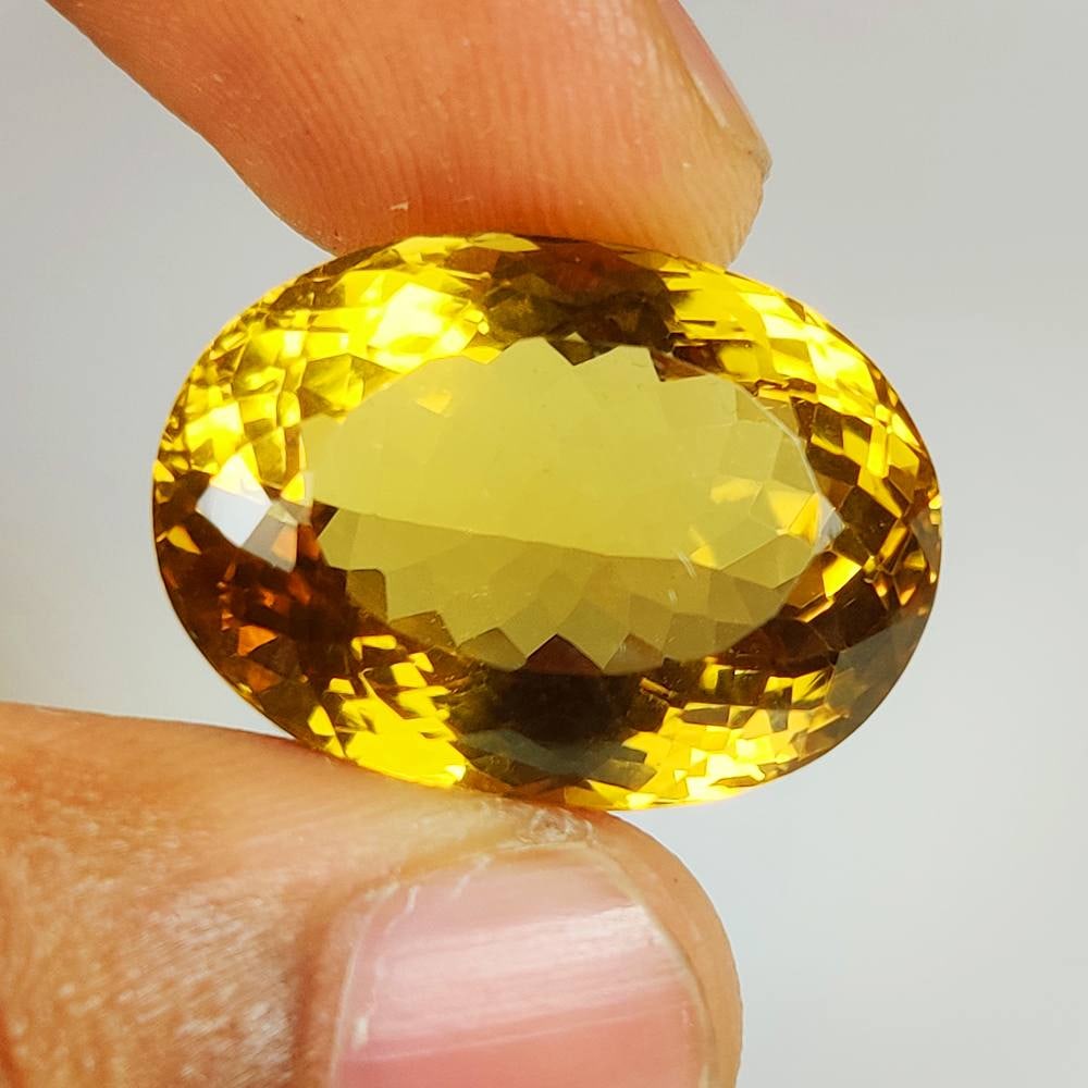 31.55 Ct Natural Yellow Citrine Oval Cut: Weight - 31.55 Ct / Size -24.00 x 16.50 x 13.00 mm / Shape - Oval Cut / Color - Yellow / Clarity - VVS / Origin - Brazil / Treatment - Heated