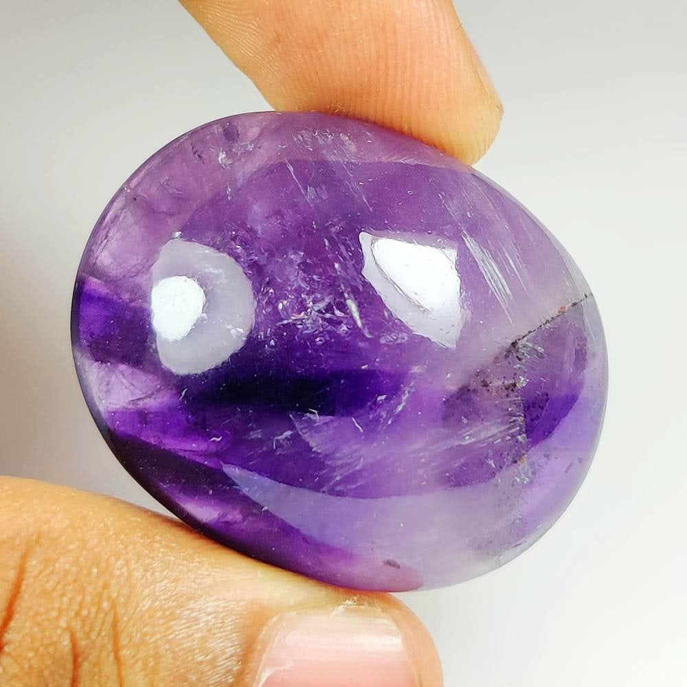100.98 Ct Natural Rutile Amethyst Quartz Oval Cab: Weight - 100.98 Ct / Dimensions - 36.80 x 31.00 x 13.80 mm / Shape - Oval Cabochon / Color - Purple / Clarity - Transparent / Origin - Norway / Treatment - None