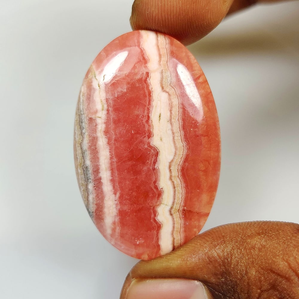 60.32 Ct Natural Rhodochrosite OVal Cab: Weight - 60.32 Ct / Size -39.00 x 25.00 x 5.40 mm / Shape - OVal Cab / Clarity - Opaque / Origin - Brazil / Treatment - None