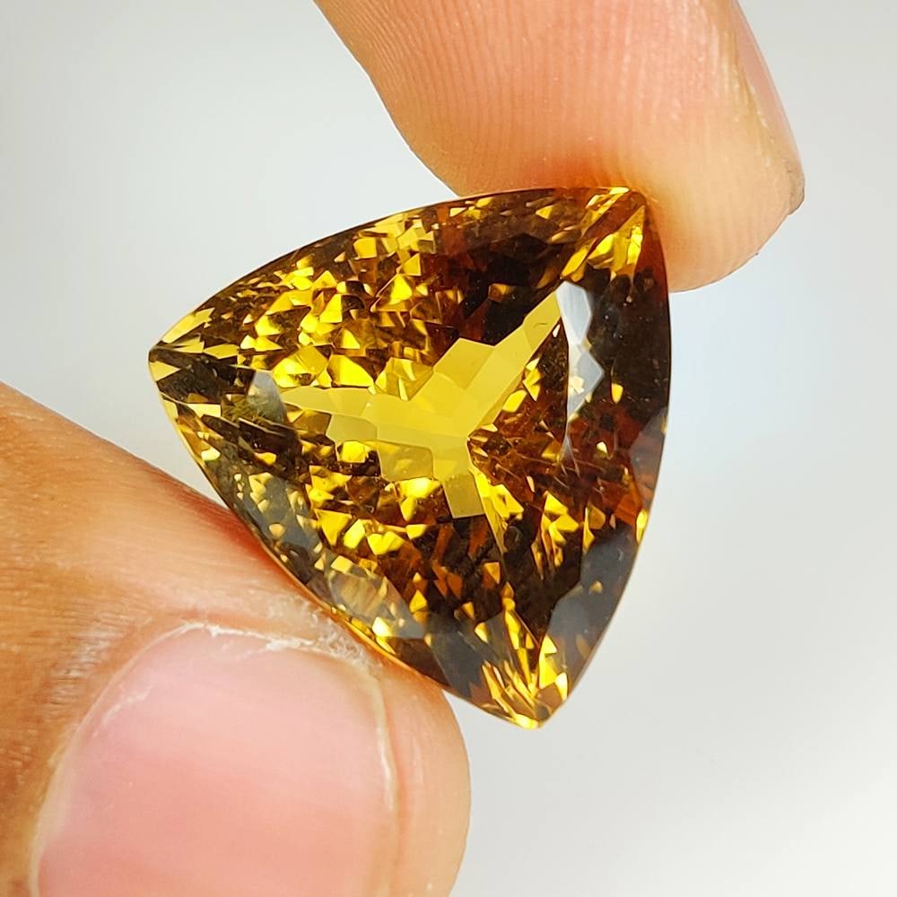 25.82 Ct Natural Honey Yellow Citrine Trillion Cut: Weight - 25.82 Ct / Dimensions - 18.90 x 18.80 x 14.20 mm / Shape & Cut - Trillion Cut / Color - Yellow / Transparency - VVS / Origin - Brazil / Comments - Heated