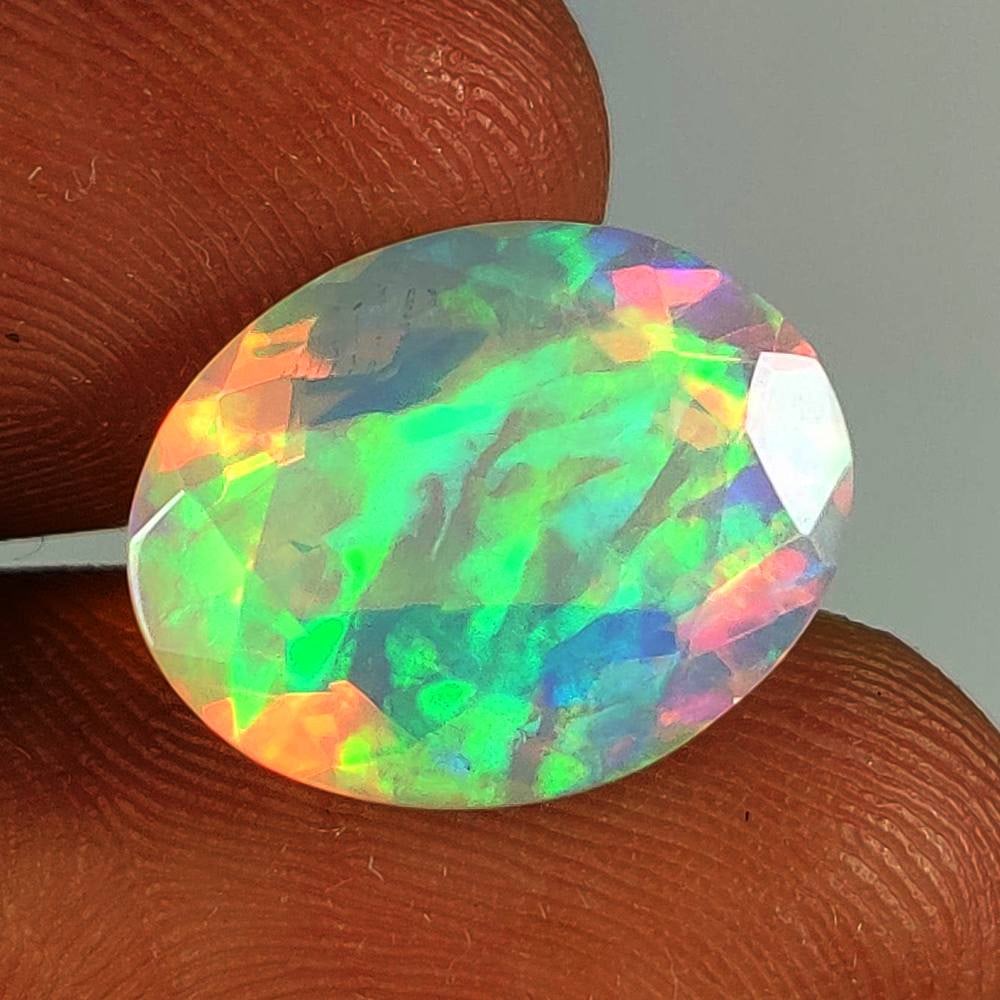 5.13 Ct Natural Multicolor Welo Fire Opal Oval Cut: Weight - 5.13 Ct / Dimensions - 15.10 x 11.90 x 6.90 mm / Shape - Oval Cut / Color - Multicolor / Clarity - Translucent / Origin - Ethiopia / Treatment - None
